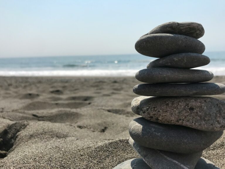 Home 11 Stack of stones on beach during daytime