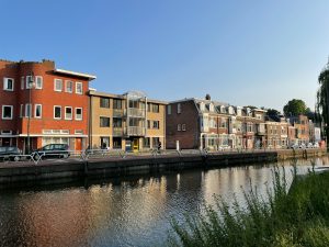 A body of water next to a row of buildings A body of water next to a row of buildings